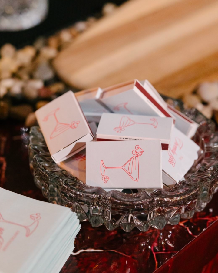 Customized matchboxes with double-sided designs, featuring hand-drawn martini illustrations. Birthday party favors.